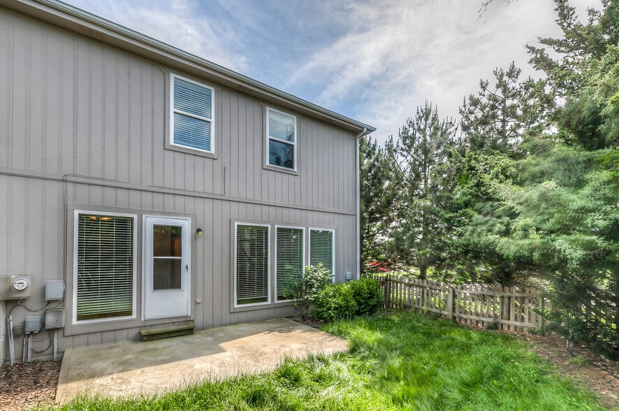 back yard with patio, fence, and treed for privacy - 22810 West 71st Terrace