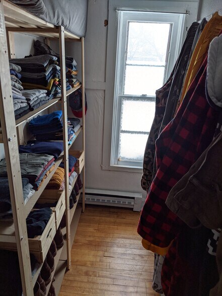 Front bedroom walk in closet with shelves and window. - 1320 Jefferson St NE
