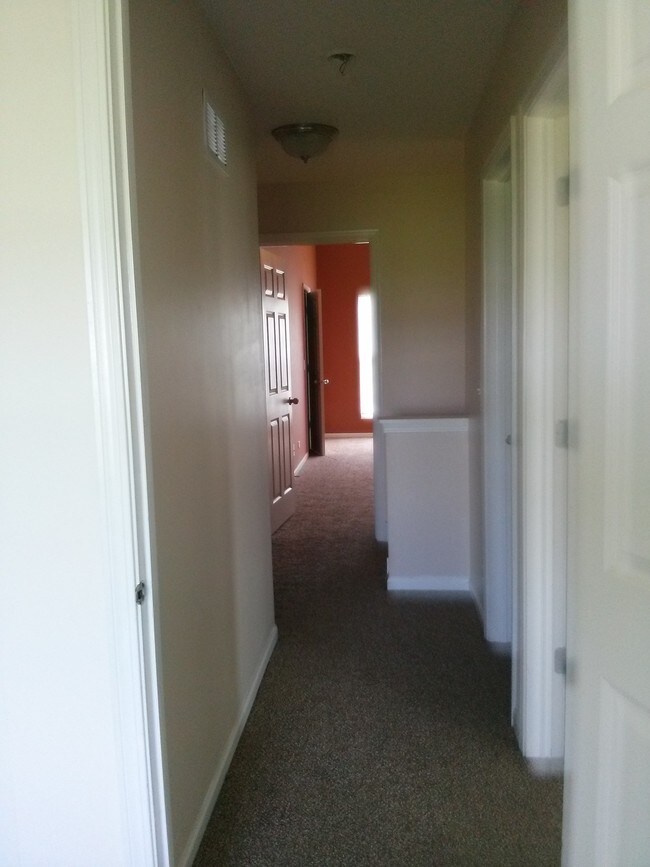 upstairs hallway leading to two bedrm, laundr - 1401 Millbrook Dr