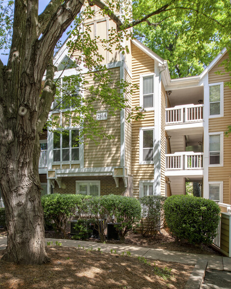 Exterior of the Villages of Eastover Glen condos surrounded by wooded and green spaces. - 2518 Cranbrook Lane