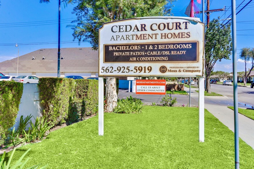 Cedar Court Apartment Homes signage, Bachelors, 1 and 2 bedrooms, private patios, cable/DSL Ready, air conditioning, 562-925-5919 - Cedar Court Apartments