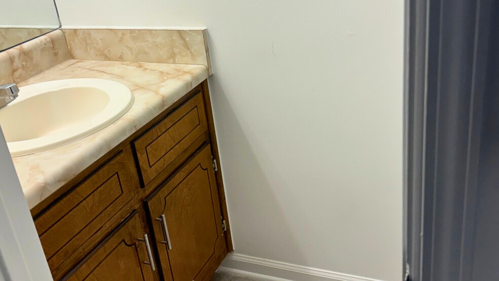 Main-level half bathroom with vanity. - 905 Park Pl NE