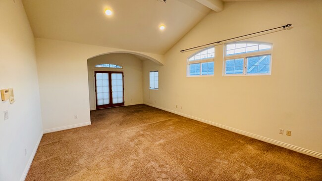 Giant primary bedroom with balcony and high vaulted ceilings - 2107 Plant Ave