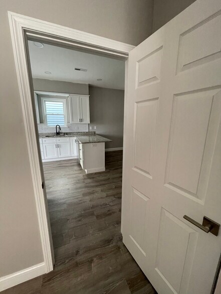 Unit two: view of open-concept kitchen from inside bedroom two. - 34 Falcon St