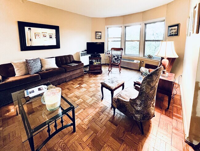 Living room with views of Dumbarton bridge over the top of magnolia trees - 2500 Q St NW