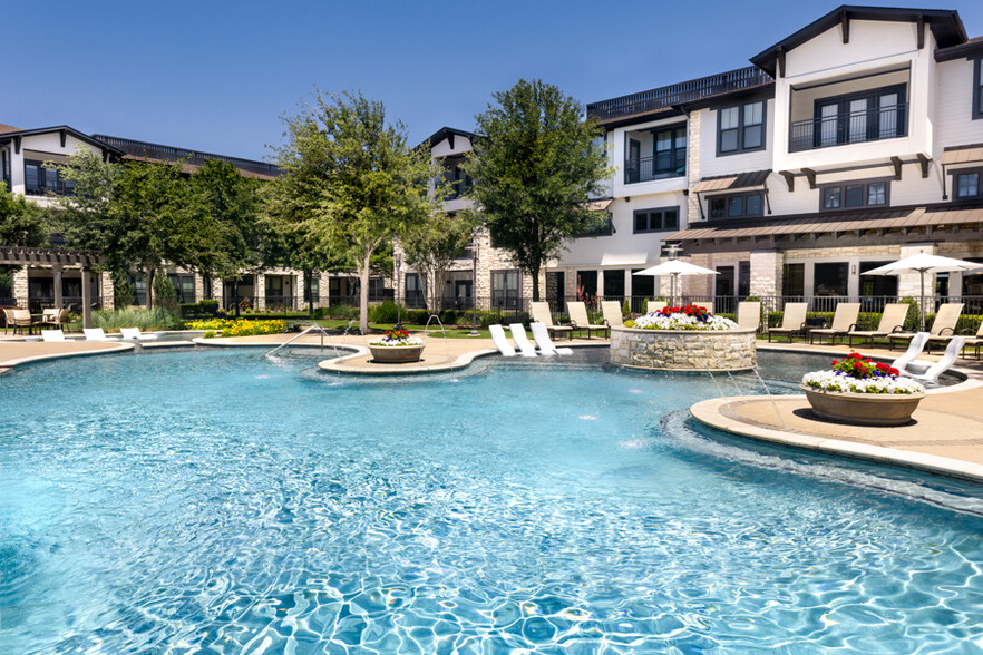 Pool includes expansive tanning area and water feature - StoneLedge