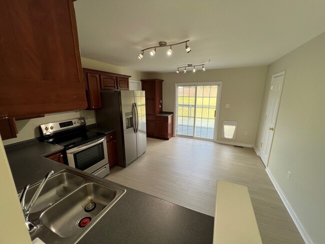 View of the Kitchen facing the Back door - 11810 White Pine Dr