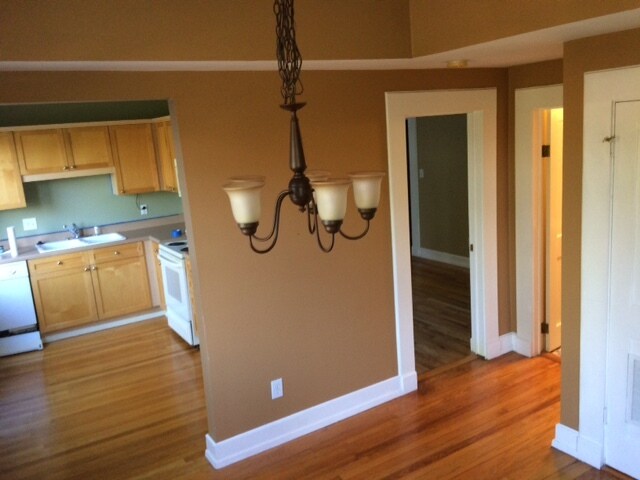Dining room leading into kitchen, bedroom and bathroom. Hardwood floors throughout and crown molding - 1028 Saint Charles Ave. NE Apt. # 7