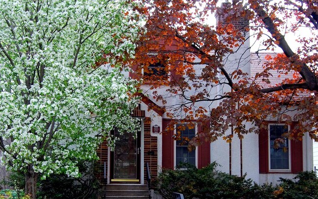 Charming exterior with mature trees and seasonal landscaping, curb appeal and a welcoming entrance. - 2923 Arthur St NE