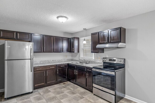 Building Photo - NE Home - Updated Kitchen and Bathrooms!  SS Appliances, Fire Place, Front Porch & Deck, Fenced Y...