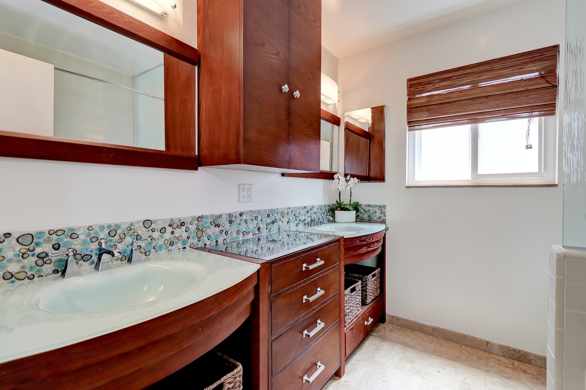 Spacious primary bath with glass tiles, two sinks and plenty of builtins. - 744 12th St
