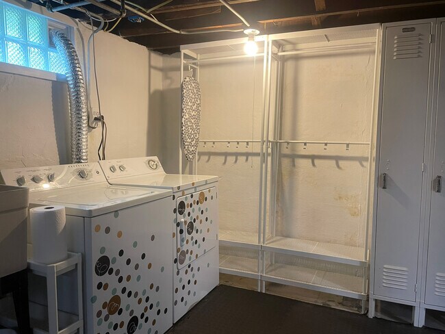 Basement laundry with open storage and utility sink - 3209 Atwood Ave
