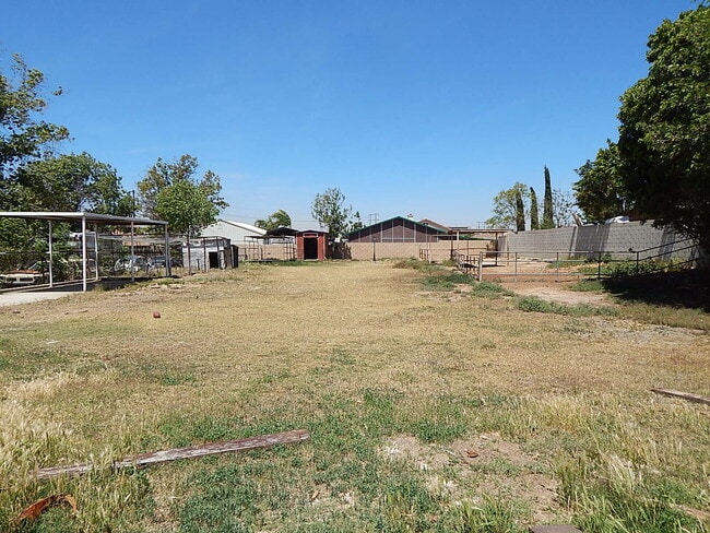 Building Photo - This property is a 3 bedroom, 2 bathroom home featuring an open floor plan with tile throughout. ...