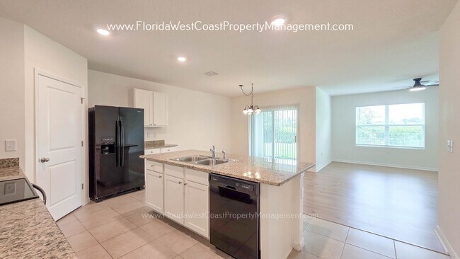 Building Photo - MOVE IN READY ! 4 BEDROOM/2 BATH! TILE- LVP THROUGHOUT! LAWN MOWING INCLUDED!
