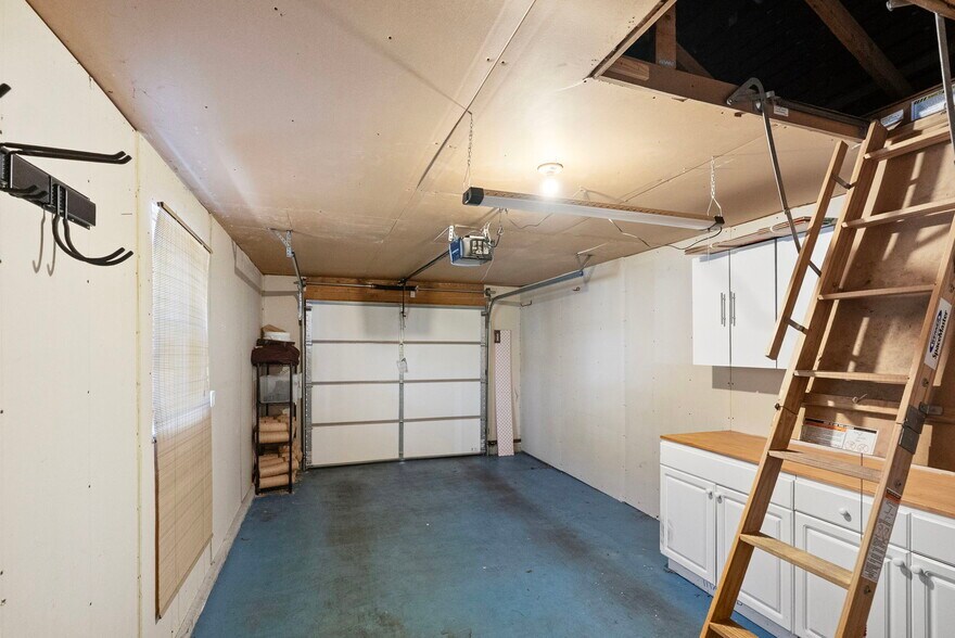 Private garage with built-in storage and workbenches, and large attic above for more storage - 1220 Weaver Rd NW