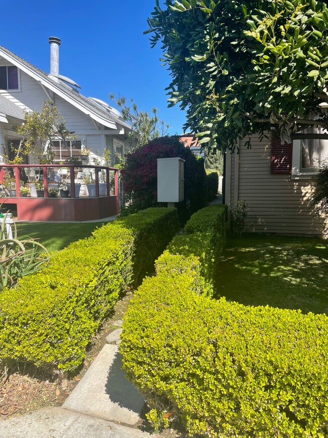 Triplex pathway, mailboxes and entry gate viewed from 3rd Street sidewalk. - 1749 E 3rd St