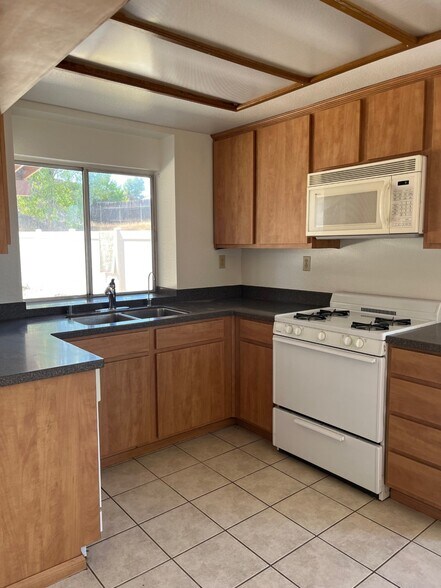 Kitchen with new cabinetry and tops - 27055 Rainbow Creek Dr