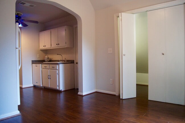 Dining room off kitchen with vaulted ceiling with washer and dryer (behind folding doors). - 629 Hillpine Dr NE
