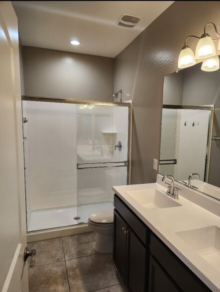 Second bathroom with standing shower and double sink - 38221 W San Ildefanso Ave