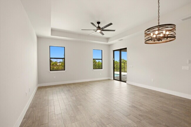 Building Photo - New 3/2 Pool Home for Rent on Canal, Fenced Yard, Pets Welcome. Your Dog Approves of This Backyard