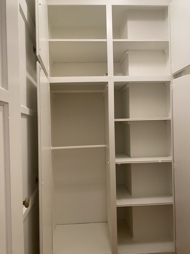 Extra closet with linen shelves to the right and storage above. - 1857 Pandora Ave