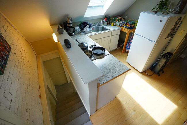 Stairs from 2nd floor entrance to kitchen with skylight - 536 Cumberland Ave