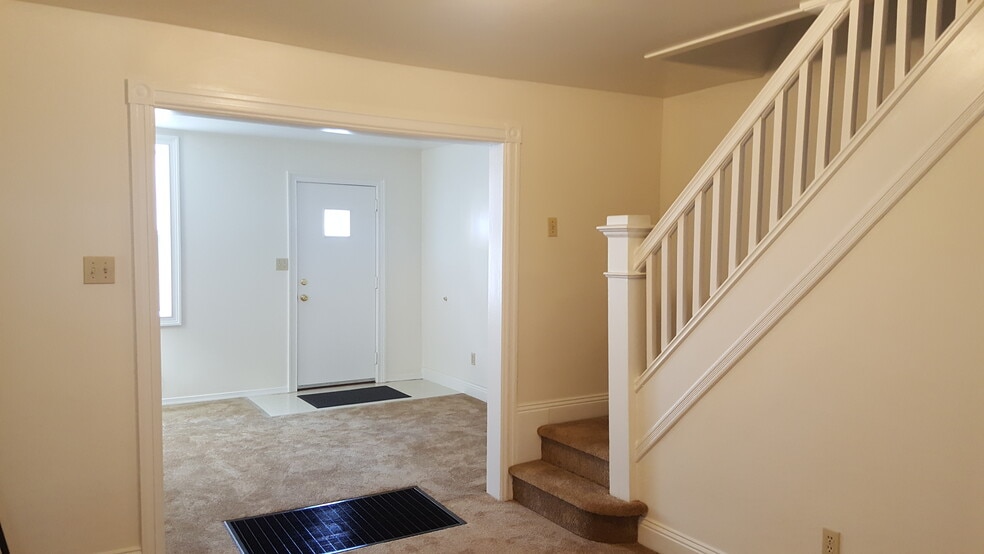 LOOKING FROM DINING ROOM TO FRONT DOOR AND STAIRS TO 2ND FLOOR - 526 Pearl St