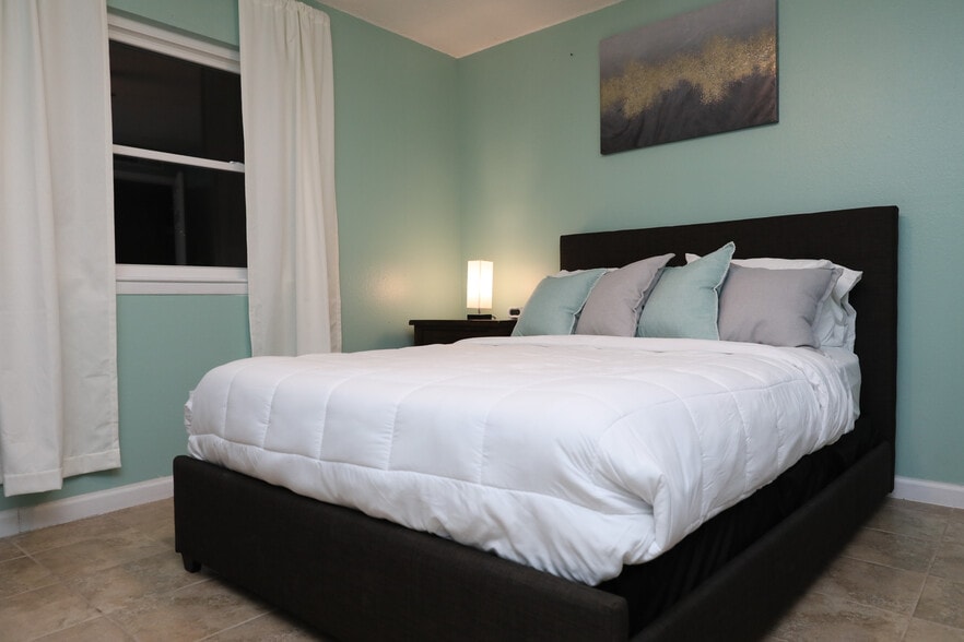 The aloe green is calming and energetic. Sleep with a smile. Light blocking curtains. - 8612 Echo St