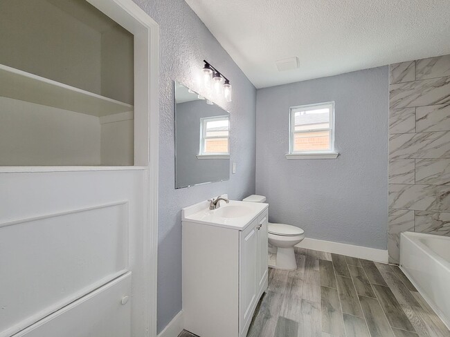 Building Photo - This beautifully updated 4-bedroom home is just under two miles from Highway 288 and Loop 610, ma...