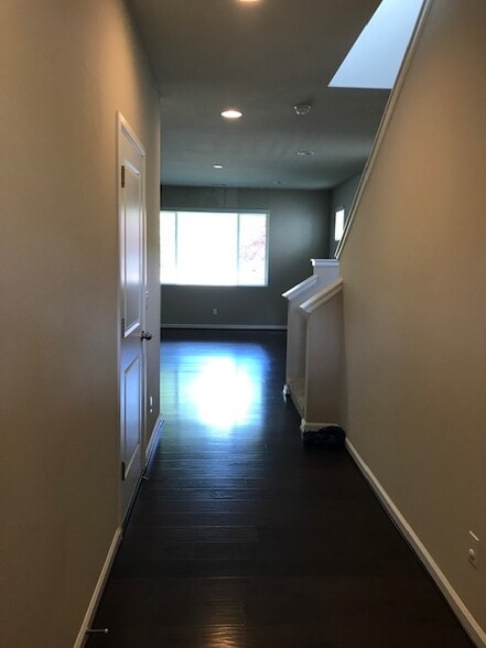 Entry from front door, entry on left from garage , stairs in R looking into living room, kitchen L - 8828 Jayden Ln NE