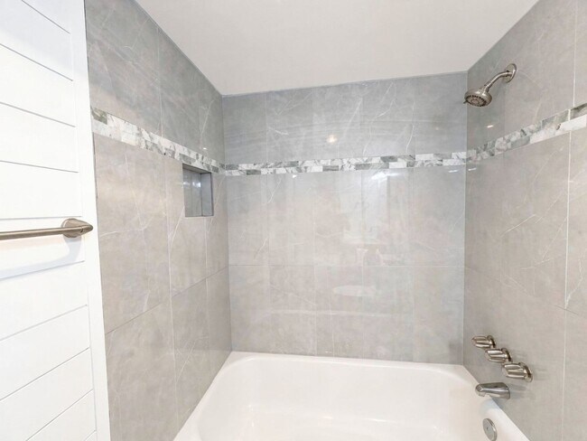 Building Photo - AVAILABLE NOW! Beautifully Renovated First-Floor Condo with Peaceful Screened Lanai