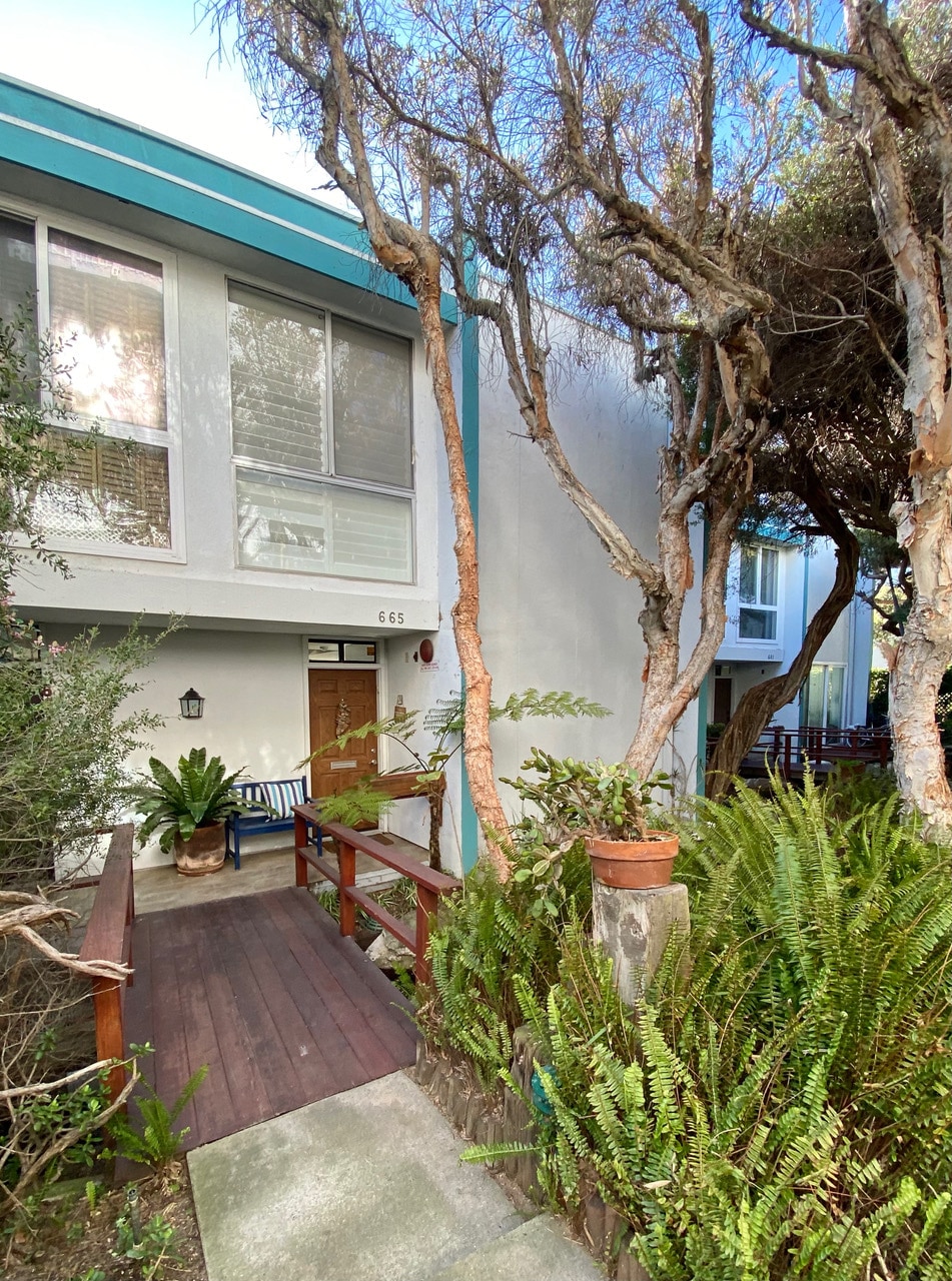 Front entrance with bridge over brookside stream - 665 The Village