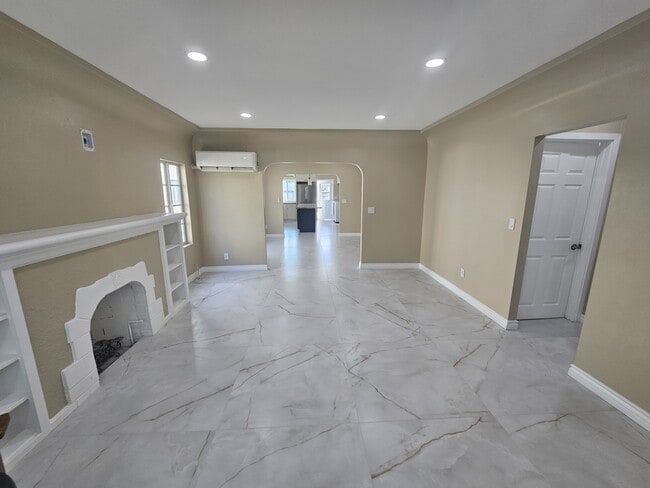 Large Living Room area with lots of natural light, fireplace, recessed lighting, new tiles and paint - 918 E Elk Ave