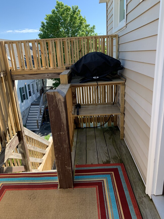 Deck with propane gas grill, chairs and small table. Tenant provides propane. - 97 Washington street