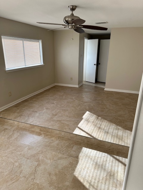 Primary bedroom with large seating area and beautiful tile flooring. Notice large windows - 128 Dallas St