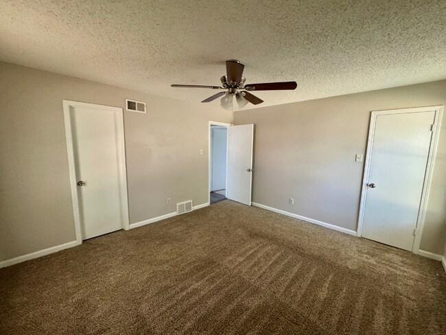 Building Photo - Charming 3BR/2BA Near Southwind | Soaring Vaulted Ceilings, Brick Fireplace & Fenced Yard