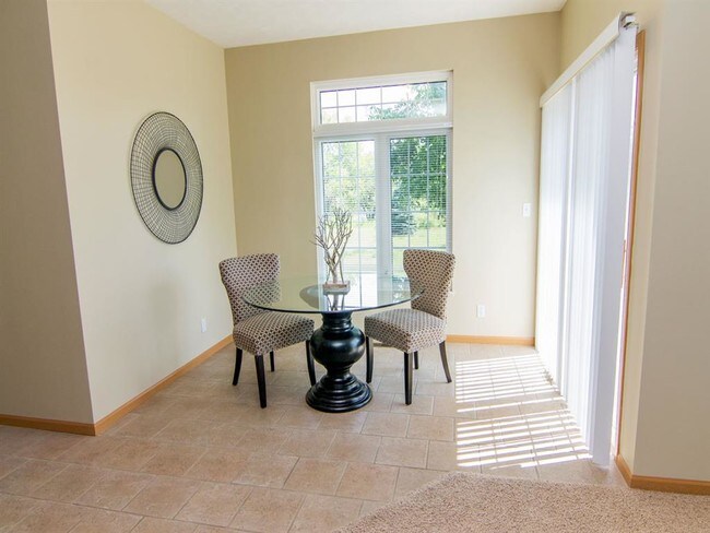 Our homes feature a spacious dining area with a sliding door leading to the deck. - Cascade Pines Duplexes