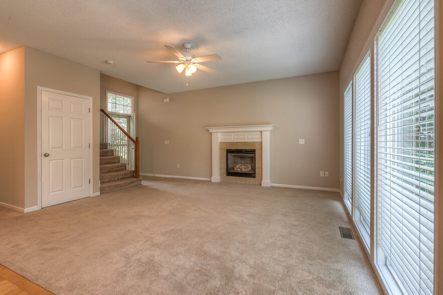 living room with large widows and firepace - 22810 West 71st Terrace