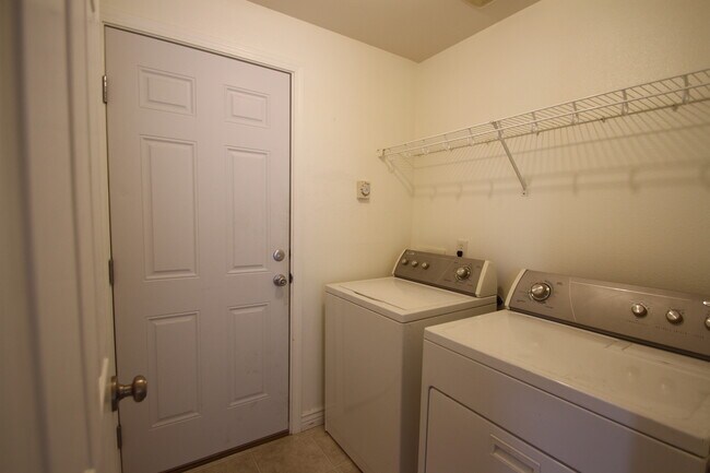 Laundry room with access to garage. - 9624 Spencer Ct