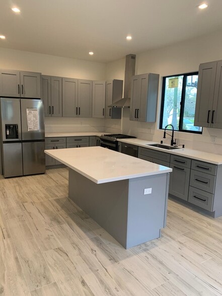 Modern kitchen with quartz countertops and brand new appliances - 20344 Lorne St