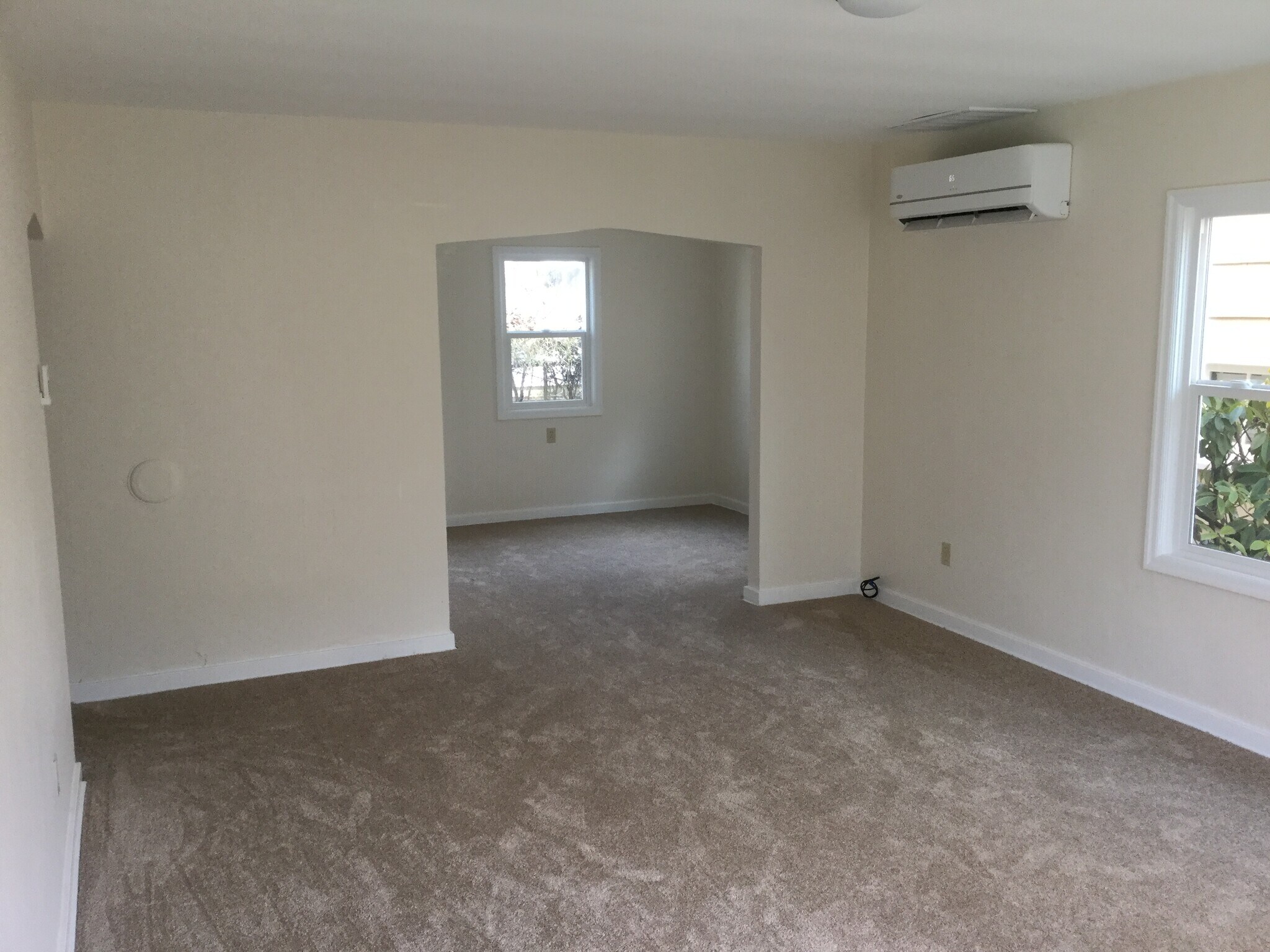 Wall-mounted efficient HVAC unit and view from living room to dining area - 1008 E 2nd St