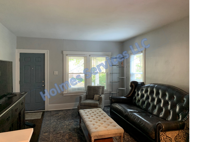 Comfy living room with gleaming hardwood floors. - 1226 Bird Ave