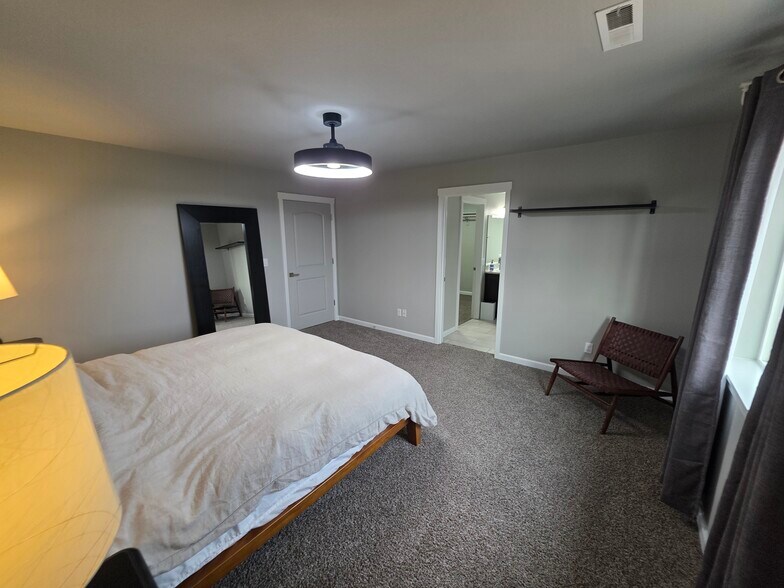 Private bedroom with floating shelf, a foldable desk in the corner where the chair is. - 10721 NE 109th St