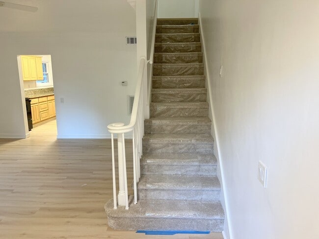 living room inside looking upstairs and back to kitchen - 4662 Carman Dr