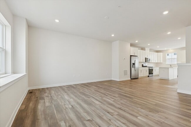 Building Photo - COMING SOON! Brand New River Pointe townhome with modern finishes, flexible living space, and a p...