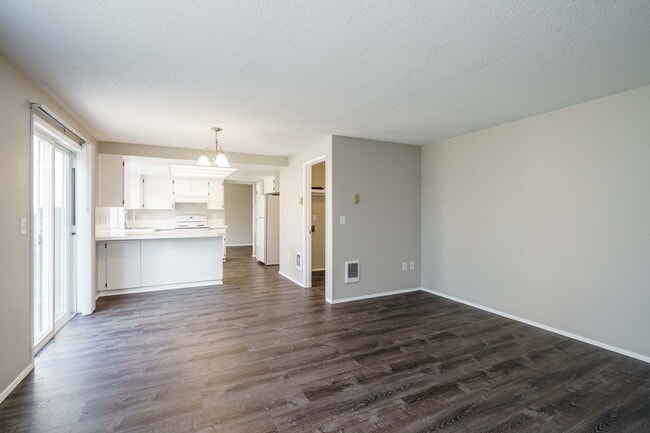 Building Photo - Recently Updated with Wood Laminate Flooring and Fresh Paint