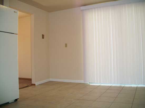 Sliding patio door in kitchen with vertical blinds included. - 502 Mercer Rd