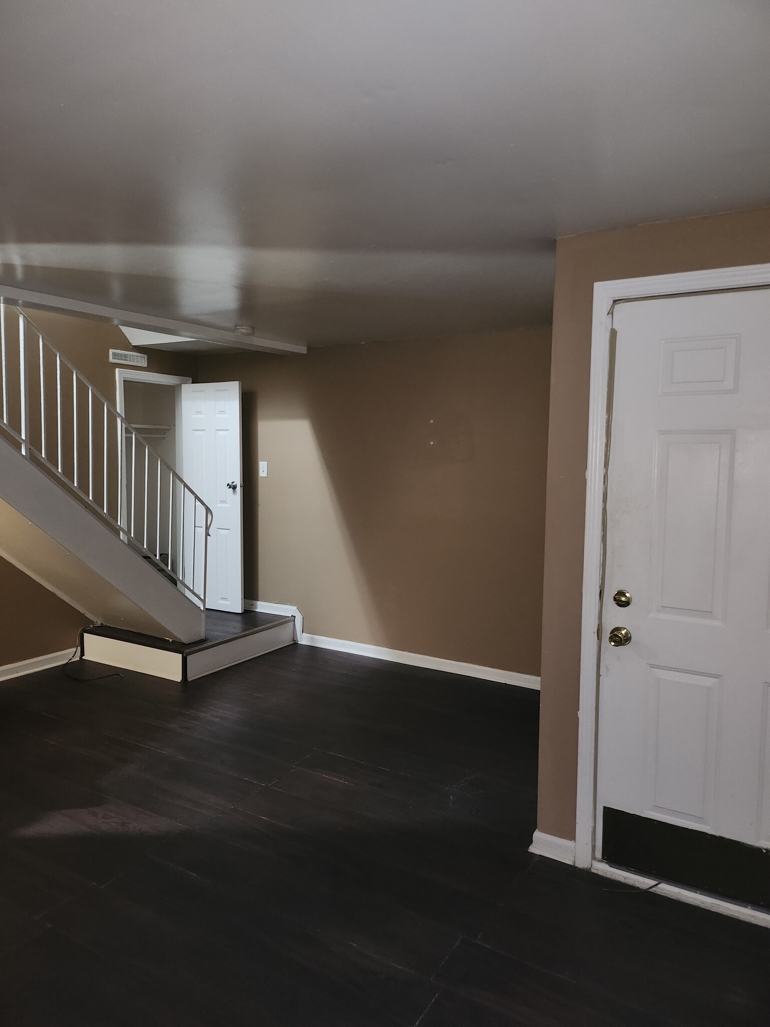 1st floor main living area. interior entry door, stair landing and coat closet - 910 Morningside Ln