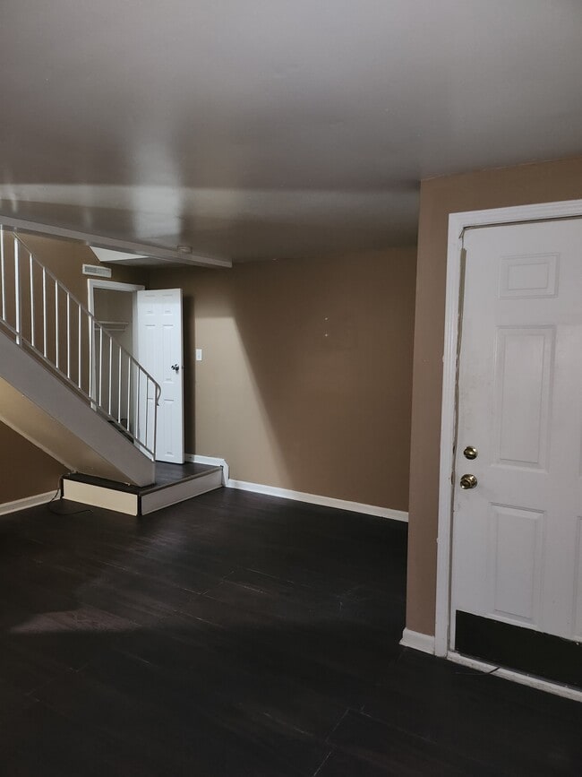 1st floor main living area. interior entry door, stair landing and coat closet - 910 Morningside Ln