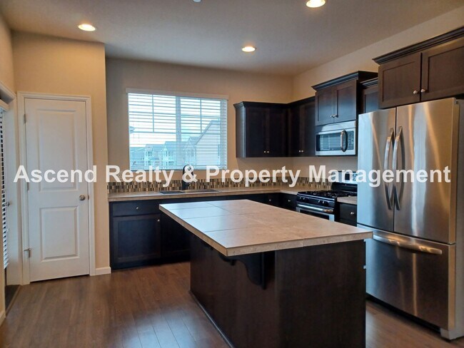 Building Photo - 3 Level End Unit Townhome with Newer Carpet, Open Floor Plan, 2 Balconies, 2 Car Attached Garage ...